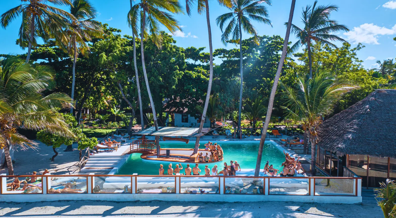 Guests enjoying the pool and social atmosphere at Tiki Beach